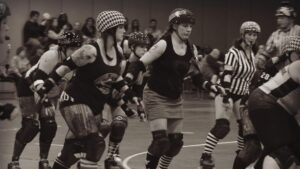 roller derby players skating during a jam with jammers and blockers in action